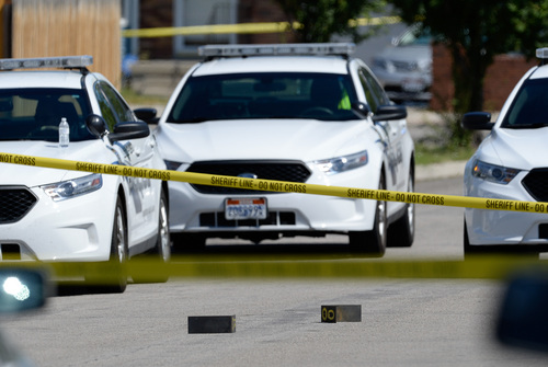 Francisco Kjolseth  |  The Salt Lake Tribune
Evidence markers can be seen on the street as Unified Police investigate the scene where one of their officers shot an armed man in Taylorsville on Friday morning, Aug 1, 2014. The man with the gun outside a residence at 5514 S. Ridgecrest (3400 West) was shot at least once and is reported in serious condition.