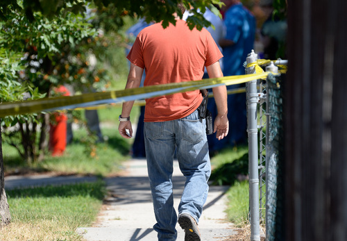 Francisco Kjolseth  |  The Salt Lake Tribune
Unified Police investigate the scene where one of their officers shot an armed man in Taylorsville on Friday morning, Aug 1, 2014. The man with the gun outside a residence at 5514 S. Ridgecrest (3400 West) was shot at least once and is reported in serious condition.