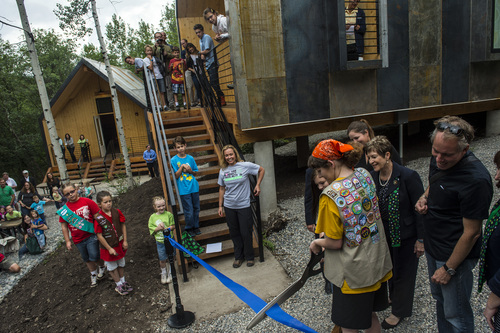 Chris Detrick  |  The Salt Lake Tribune
Girl Scouts Megan Lundberg and Callie Privett cut the ribbon during a ceremony at Trefoil Ranch in Provo Canyon on Wednesday. The University of Utah's architecture school partnered with the Girl Scouts of Utah for a cabin building project. Leaders from the school have worked for the past year with a group of girl scouts to design three cabins at a girl scout camp.