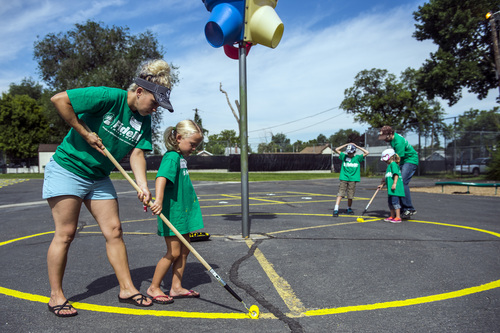 Chris Detrick  |  The Salt Lake Tribune
Jaynee Piontkowski and her daughter Jayla, 5, help to repaint the playground at Jackson Elementary School in Salt Lake City on Saturday. Over two hundred Fidelity Investments volunteers worked alongside students and teachers as part of the company's "School Transformation Day" program. Among other things, volunteers will be building a reading corner in the library, painting college-themed murals, building new garden beds and building two new First LEGO League tables for the school's robotics program.