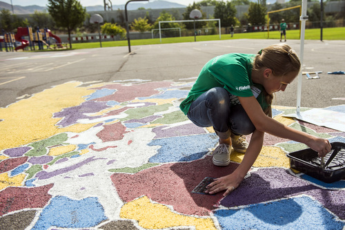 Chris Detrick  |  The Salt Lake Tribune
Jackie Hulm helps to paint a world map at Jackson Elementary School in Salt Lake City Saturday August 2, 2014. Over two hundred Fidelity Investments volunteers worked alongside students and teachers as part of the company's "School Transformation Day" program. Among other things, volunteers will be building a reading corner in the library, painting college-themed murals, building new garden beds and building two new First LEGO League tables for the school's robotics program.