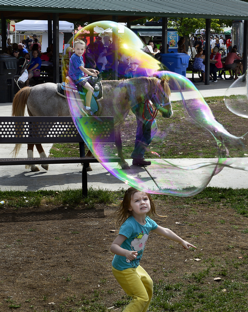 Scott Sommerdorf   |  The Salt Lake Tribune
Pony rides and chasing bubbles at The Monster Bubbles booth at the Wasatch Front Farmers Market at Wheeler Historic Farm were both popular, Sunday, August 3, 2014. Sunday was the kickoff of National Farmers Market Week.