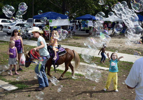 Scott Sommerdorf   |  The Salt Lake Tribune
Pony rides and chasing bubbles at The Monster Bubbles booth at the Wasatch Front Farmers Market at Wheeler Historic Farm were both popular, Sunday, August 3, 2014. Sunday was the kickoff of National Farmers Market Week.