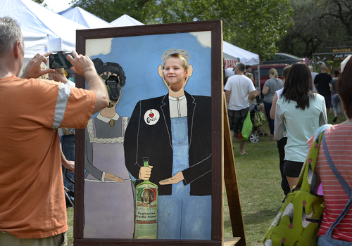 Scott Sommerdorf   |  The Salt Lake Tribune
Toby Hardin, 7, had his photo made by his father inside the classic "American Gothic" painting depicting a farmer and his wife, Sunday, August 3, 2014. The family was visiting the Wasatch Front Farmers Market at Wheeler Historic Farm, on the day that National Farmer's Market Week kicked off.