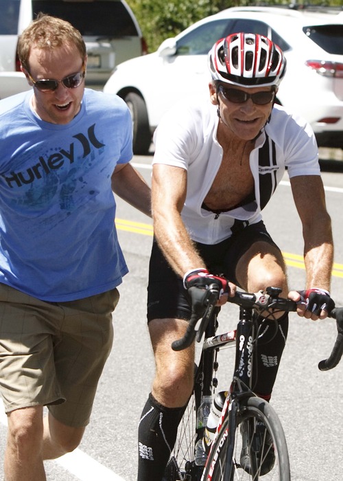 Leah Hogsten | The Salt Lake Tribune
Jeff Jackson gives his father Dave Jackson, 62, a push up Little Cottonwood Canyon during the Ultimate Challenge non-competitive amateur stage of the Tour of Utah. Stage 5 was a full 113 miles, starting at Snowbasin Resort and ending at Snowbird Ski and Summer Resort, Saturday, August 10, 2013.