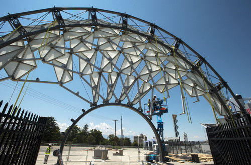 Steve Griffin  |  The Salt Lake Tribune


A crew from Erichsen Construction Services starts to dismantle the Hoberman Arch from Rice-Eccles stadium in Salt Lake City, Utah Friday, August 1, 2014. The university is giving it to Salt Lake City. The city doesn't know yet what it will do with the Olympic Legacy sculpture but, for the time being, will put it in storage.