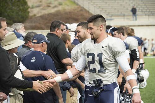 Rick Egan  |  The Salt Lake Tribune

Brian Suite (21) shakes hands with fans after the final Utah State spring scrimmage, Saturday, April 12, 2014.