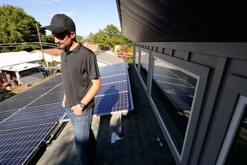 Francisco Kjolseth  |  The Salt Lake Tribune
Salt Lake City resident Jared Campbell generates more power than he can use from the 40 photovoltaic panels on the roofs of his garage and Highland Park home. On a sunny summer day, his home pipes 40 kilowatts into Rocky Mountain Power's grid, yet Utah's largest utility contends this power is not all that valuable. RMP is seeking to impose a monthly $4.65 "facilities charge" on net-metered customers like Campbell to ensure they pay their share of the grid's fixed costs.