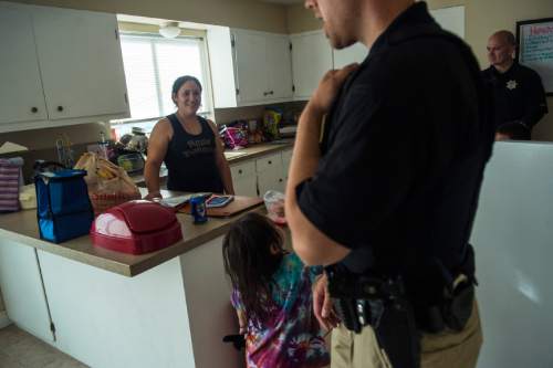 Chris Detrick  |  The Salt Lake Tribune
Adult Probation and Parole agent Chris Moore, left, and Assistant Regional Administrator Nathan Griffiths talk with probationer Elisa Kelly, 29, during an unscheduled visit at her home in West Valley City Thursday July 31, 2014.