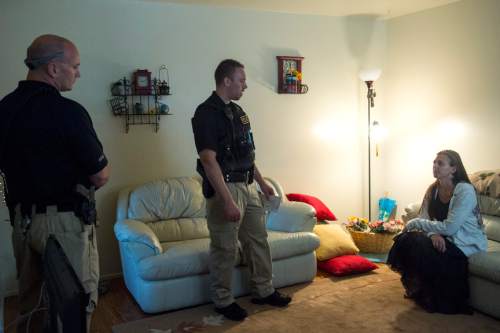 Chris Detrick  |  The Salt Lake Tribune
Adult Probation and Parole agent Chris Moore, center, and and Assistant Regional Administrator Nathan Griffiths talk with probationer Brittanie Yeaman, 37, during an unscheduled visit at her home Thursday July 31, 2014.