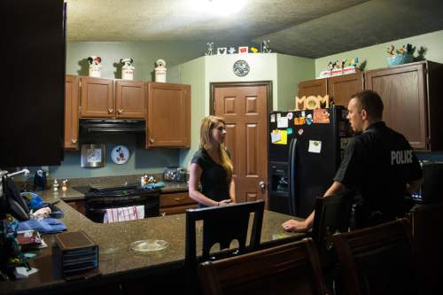 Chris Detrick  |  The Salt Lake Tribune
Adult Probation and Parole agent Chris Moore talks with probationer Brandi Corso, 23, during an unscheduled visit at her home Thursday July 31, 2014.