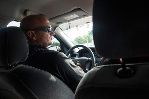 Chris Detrick  |  The Salt Lake Tribune
Adult Probation and Parole Assistant Regional Administrator Nathan Griffiths drives to the apartment of a probationer in West Valley City for an unscheduled visit Thursday July 31, 2014.