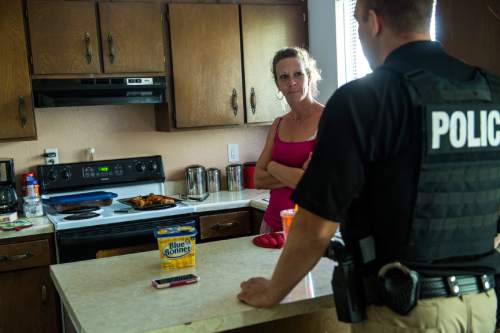 Chris Detrick  |  The Salt Lake Tribune
Adult Probation and Parole agent Chris Moore talks with probationer Cheri Holbrook, 38, during an unscheduled visit at her home Thursday July 31, 2014.
