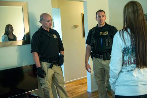 Chris Detrick  |  The Salt Lake Tribune
Adult Probation and Parole agent Chris Moore, center, and and Assistant Regional Administrator Nathan Griffiths talk with probationer Brittanie Yeaman, 37, during an unscheduled visit at her home Thursday July 31, 2014.