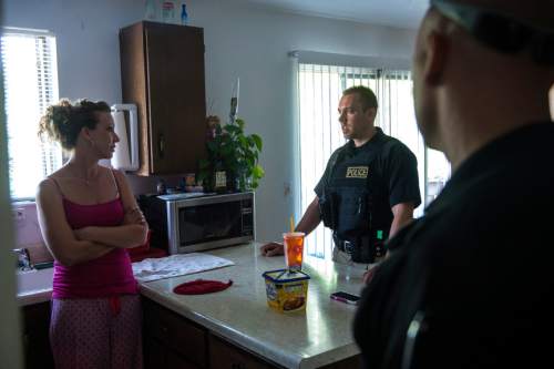Chris Detrick  |  The Salt Lake Tribune
Adult Probation and Parole agent Chris Moore, center, and and Assistant Regional Administrator Nathan Griffiths talk with probationer Cheri Holbrook, 38, during an unscheduled visit at her home Thursday July 31, 2014.