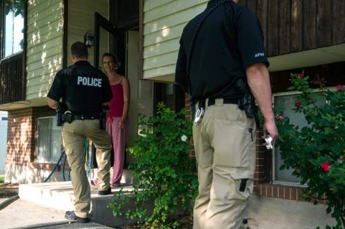 Chris Detrick  |  The Salt Lake Tribune
Adult Probation and Parole agent Chris Moore, left, and and Assistant Regional Administrator Nathan Griffiths talk with probationer Cheri Holbrook, 38, during an unscheduled visit at her home Thursday July 31, 2014.