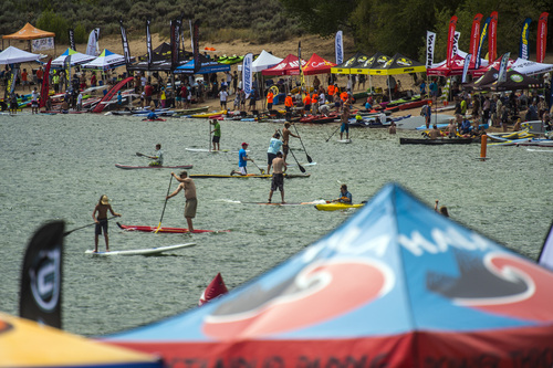 Chris Detrick  |  The Salt Lake Tribune
Outdoor Retailer show attendees try out stand up paddle boards, kayaks, kiteboards, and other water sport activities during the Open Air Demo at Pineview Reservoir Tuesday August 5, 2014.  The Open Air Demo experience puts the industry's pioneering gear into the hands of key retail decision makers and media, giving them first-hand experience and insight into the latest apparel, camping, fly fishing, GPS/geocaching, hiking, hydration, paddle sports, SUP, travel and trail running-focused products. Outdoor Retailer (OR) brings together retailers, manufacturers, industry advocates and media to conduct the business of outdoor recreation through trade shows, product demo events and web-based business solutions.