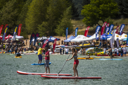 Chris Detrick  |  The Salt Lake Tribune
Outdoor Retailer show attendees try out stand up paddle boards, kayaks, kiteboards, and other water sport activities during the Open Air Demo at Pineview Reservoir Tuesday August 5, 2014.  The Open Air Demo experience puts the industry's pioneering gear into the hands of key retail decision makers and media, giving them first-hand experience and insight into the latest apparel, camping, fly fishing, GPS/geocaching, hiking, hydration, paddle sports, SUP, travel and trail running-focused products. Outdoor Retailer (OR) brings together retailers, manufacturers, industry advocates and media to conduct the business of outdoor recreation through trade shows, product demo events and web-based business solutions.