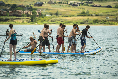 Chris Detrick  |  The Salt Lake Tribune
Outdoor Retailer show attendees try out stand up paddle boards, kayaks, kiteboards, and other water sport activities during the Open Air Demo at Pineview Reservoir Tuesday August 5, 2014.  The Open Air Demo experience puts the industryís pioneering gear into the hands of key retail decision makers and media, giving them first-hand experience and insight into the latest apparel, camping, fly fishing, GPS/geocaching, hiking, hydration, paddle sports, SUP, travel and trail running-focused products. Outdoor Retailer (OR) brings together retailers, manufacturers, industry advocates and media to conduct the business of outdoor recreation through trade shows, product demo events and web-based business solutions.
