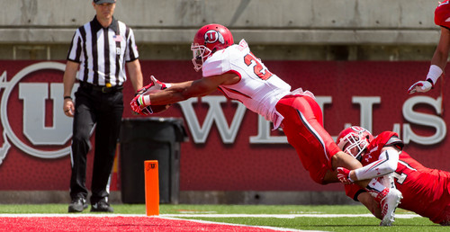 Trent Nelson  |  The Salt Lake Tribune
Utah's Devontae Booker dives into the end zone, with Evan Eggiman hanging on during the University of Utah's Red & White football game at Rice-Eccles Stadium in Salt Lake City, Saturday April 19, 2014.