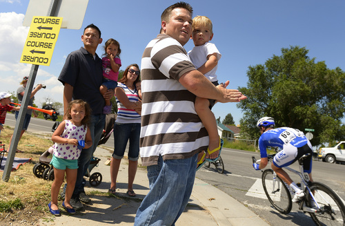 Leah Hogsten  |  The Salt Lake Tribune
l-r Tyson Murri, wife Meghan and daughters Brylie and Laetyn cheer on the cyclists with good friend James Phelps holding his son Levi.  2014 Tour of Utah cyclists turn off Coleman Ave. onto Utah Ave. in Tooele during Wednesday's 118.3-mile stage as they make their way to Miller Motorsports Park, August 6, 2014.