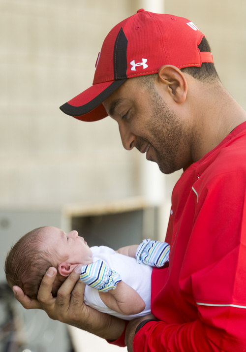 Rick Egan  |  The Salt Lake Tribune

Wide receiver coach, Taylor Stubblefield, holds Jagger, his two-week-old baby boy after practice at Rice Eccles Stadium, Wednesday, August 6, 2014
