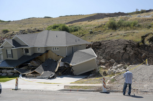 Al Hartmann  |  The Salt Lake Tribune 
A home destroyed by landslide at Parkway Dr. in North Salt Lake. Residents returned to their homes Wednesday Aug. 6, 2014, a day after a landslide destroyed the home and others had to be evacuated.