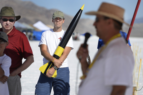 Scott Sommerdorf   |  The Salt Lake Tribune
Paul Lambert of Pleasant Grove, holding his J-250 rocket, listens to the day's safety meeting, and informational gathering at the main tent, Saturday, August 2, 2014. The FAA gave the Utah Rocket Club clearance to launch rockets up to 25,000 feet from the Salt Flats, for four days. The annual launch, named Hellfire, was held Thursday July 31 to Sunday Aug. 3, 2014.