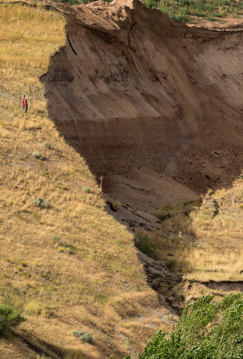Trent Nelson  |  The Salt Lake Tribune
Workers inspecting a large landslide in North Salt Lake that destroyed one home and caused the evacuation of dozens more, Tuesday August 5, 2014.