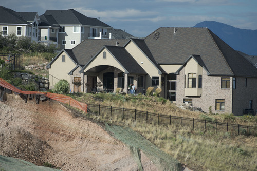 Jeremy Harmon  |  The Salt Lake Tribune

Landslide damage is seen very close to this home on the hillside above Parkway Drive in North Salt Lake on Tuesday, August 5, 2014.