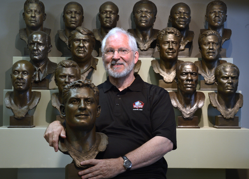 Scott Sommerdorf   |  The Salt Lake Tribune
Sculptor Blair Buswell holds the replica of the NFL Hall of Fame bust of Steve Young, as other Hall of Fame coaches and players sit behind him in his Pleasant Grove studio, Wednesday, August 6, 2014. Buswell has done many busts for the NFL Hall of Fame and numerous other sports-related sculptures.