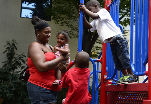 Scott Sommerdorf   |  The Salt Lake Tribune
Kendra Hardrit plays with her niece Pazian Holliman, 1, along with her nephew Pierre Holliman, 3, top, and her own son, Avanti Hardrit, 3, below in the playground at the Road Home, Wednesday, August 6, 2014. The economy may be rebounding but homeless kids in Salt Lake City still abound. The Road Home has 50 percent more kids this year than in 2008. The shelter is seeking back-to-school donations.