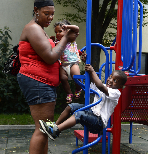 Scott Sommerdorf   |  The Salt Lake Tribune
Kendra Hardrit plays with her niece Pazian Holliman, 1, along with her nephew Pierre Holliman, 3, in the playground at the Road Home, Wednesday, August 6, 2014. The economy may be rebounding but homeless kids in Salt Lake City still abound. The Road Home has 50 percent more kids this year than in 2008. The shelter is seeking back-to-school donations.