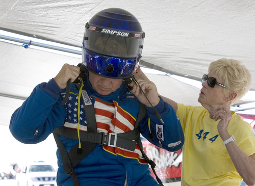 Paul Fraughton  |   Salt Lake Tribune
   With the help of his wife Karen, Dave Spangler tries on his helmet as the team prepared for a run which was delayed due to a safety concern.                    
 Tuesday, August 13, 2013