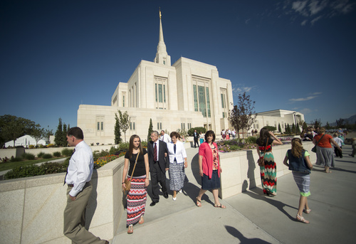 Rick Egan  |  The Salt Lake Tribune

Guests take photos and explore the grounds of the Ogden Temple, on the first day of the public open house, Friday, August 1, 2014.  The temple will be formally rededicated in three sessions on Sunday, September 21, 2014