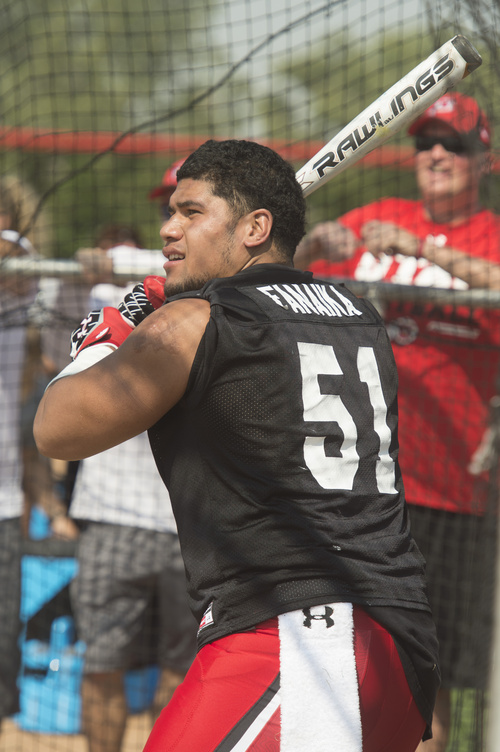 Rick Egan  |  The Salt Lake Tribune

Defensive end  Jason Fanaika, takes his turn at bat, during the home run derby competition after the University of Utah football practice, Saturday, August 9, 2014