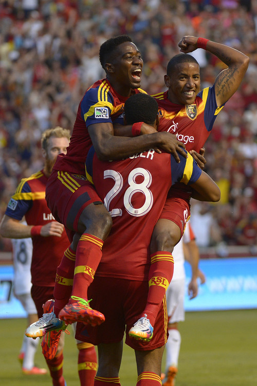 Leah Hogsten  |  The Salt Lake Tribune
Real Salt Lake forward Olmes Garcia (13) and  Real Salt Lake forward Joao Plata (8) jump into the arms of Real Salt Lake defender Chris Schuler (28) after one of Schuler's two goals during the first half of their matchup as Real Salt Lake leads D. C. United 3-0 Saturday, August 9, 2014, at Rio Tinto Stadium.