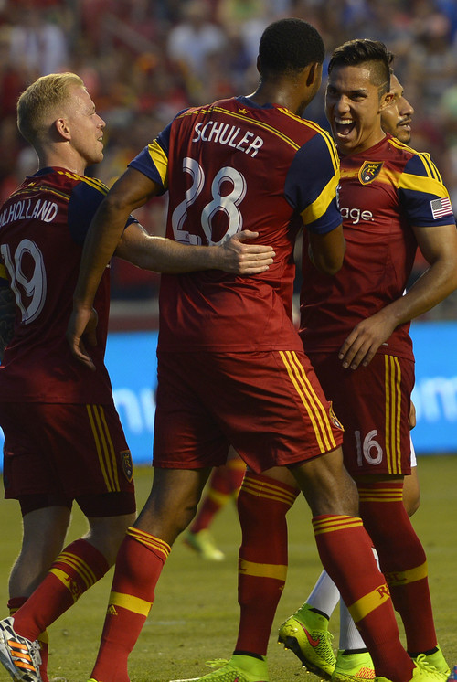 Leah Hogsten  |  The Salt Lake Tribune
Real Salt Lake defender Chris Schuler (28) is congratulated for his second goal with Real Salt Lake midfielder Javier Morales (11) and Real Salt Lake midfielder Luke Mulholland (19) during the first half of their matchup as Real Salt Lake leads D. C. United 3-0 Saturday, August 9, 2014, at Rio Tinto Stadium.