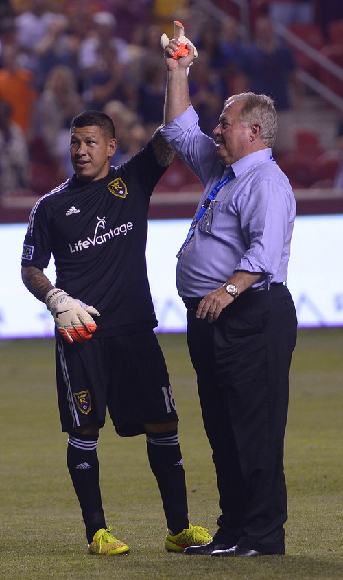 Leah Hogsten  |  The Salt Lake Tribune
Real Salt Lake goalkeeper Nick Rimando (18) celebrates his new MLS record for career game shutouts at 113 with team owner Del Loy Hansen. 
Real Salt Lake defeated D. C. United 3-0 Saturday, August 9, 2014, at Rio Tinto Stadium.