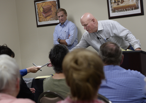 Scott Sommerdorf   |  The Salt Lake Tribune
UEP fiduciary Bruce Wisan is handed the list of 26 people who will recieve a home from the UEP distribution plan at a meeting held at Mohave Community College to discuss the UEP distribution, Saturday, August 9, 2014.