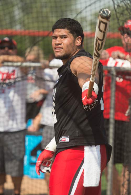 Rick Egan  |  The Salt Lake Tribune

Defensive end  Jason Fanaika, takes his turn at bat, during the home run derby competition after the University of Utah football practice, Saturday, August 9, 2014