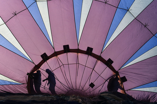 Keith Johnson | The Salt Lake Tribune

Midnight Blue crew members prepare to launch their hot air balloon in the Valley of the Gods in Southeastern Utah on the last day of the16th annual Bluff Balloon Festival outside Bluff, Utah January 19, 2014.