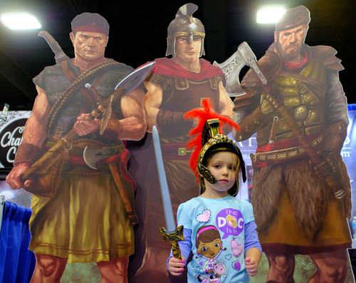 Trent Nelson  |  The Salt Lake Tribune
Mackenzie Winslow poses with a sword and helmet in front of Teancum, Moroni, and Lehi, characters from a new  series of epic fiction books, "The War Chapters," seen at the Latter-day Expo on Saturday at the South Towne Expo Center in Sandy.