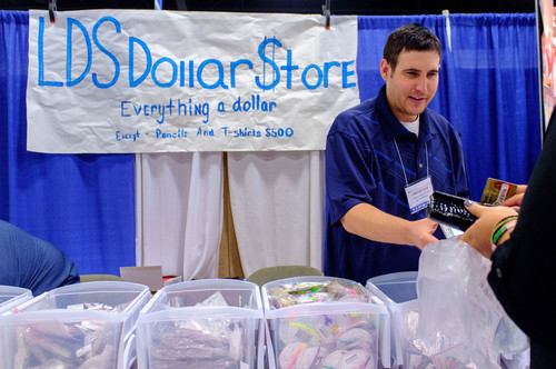 Trent Nelson  |  The Salt Lake Tribune
Chris Krueger handles a transaction at the LDS Dollar Store at the first Latter-day Expo Saturday August 9, 2014 at the South Towne Expo Center in Sandy.