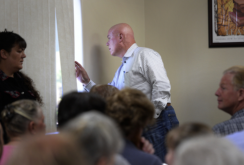Scott Sommerdorf   |  The Salt Lake Tribune
UEP fiduciary Bruce Wisan looks through a window to see how many more people may be on the way to a meeting held at Mohave Community College in Colorado City to discuss the UEP distribution, Saturday, August 9, 2014.