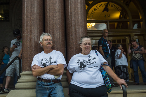 Chris Detrick  |  The Salt Lake Tribune
Shawn Gillard, of Salt Lake City, and Susan Bowlden, of South Salt Lake City, attend a Justice for Geist rally outside of City HallTuesday August 12, 2014.  Salt Lake City police Officer Brett Olsen shot Geist on June 18 during a search for a missing 3-year-old boy, who was later found asleep in his own basement.