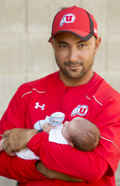 Rick Egan  |  The Salt Lake Tribune

Wide reciever coach, Taylor Stubblefield, holds his two-week-old baby Jagger, practice at Rice Eccles Stadium, Wednesday, August 6, 2014