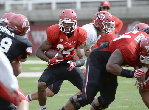 Al Hartmann  |  The Salt Lake Tribune 
Running back Bubba Poole looks for an opening during practice at Ute football camp Wednesday August 13, 2014.