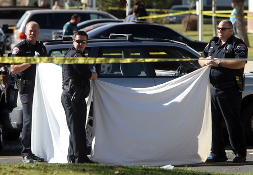 Rick Egan  | The Salt Lake Tribune 
Officers block the view of Danielle Willard's body at the Lexington Park apartments in West Valley City, after she was shot on Friday, Nov. 2, 2012. On March 21, 2013, WVC police identified the two officers who shot Willard and more details about what happened.