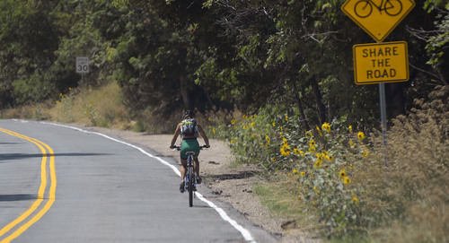 Al Hartmann  |  The Salt Lake Tribune 
A biker makes her way down Millcreek Canyon's narrow shoulder Tuesday August 12, 2014.  Salt Lake County is shifting $300,000 within its budget to make biking safer in Millcreek Canyon.